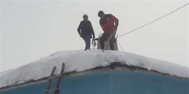 Fedakar öğretmen, okulun çatısındaki karları temizledi